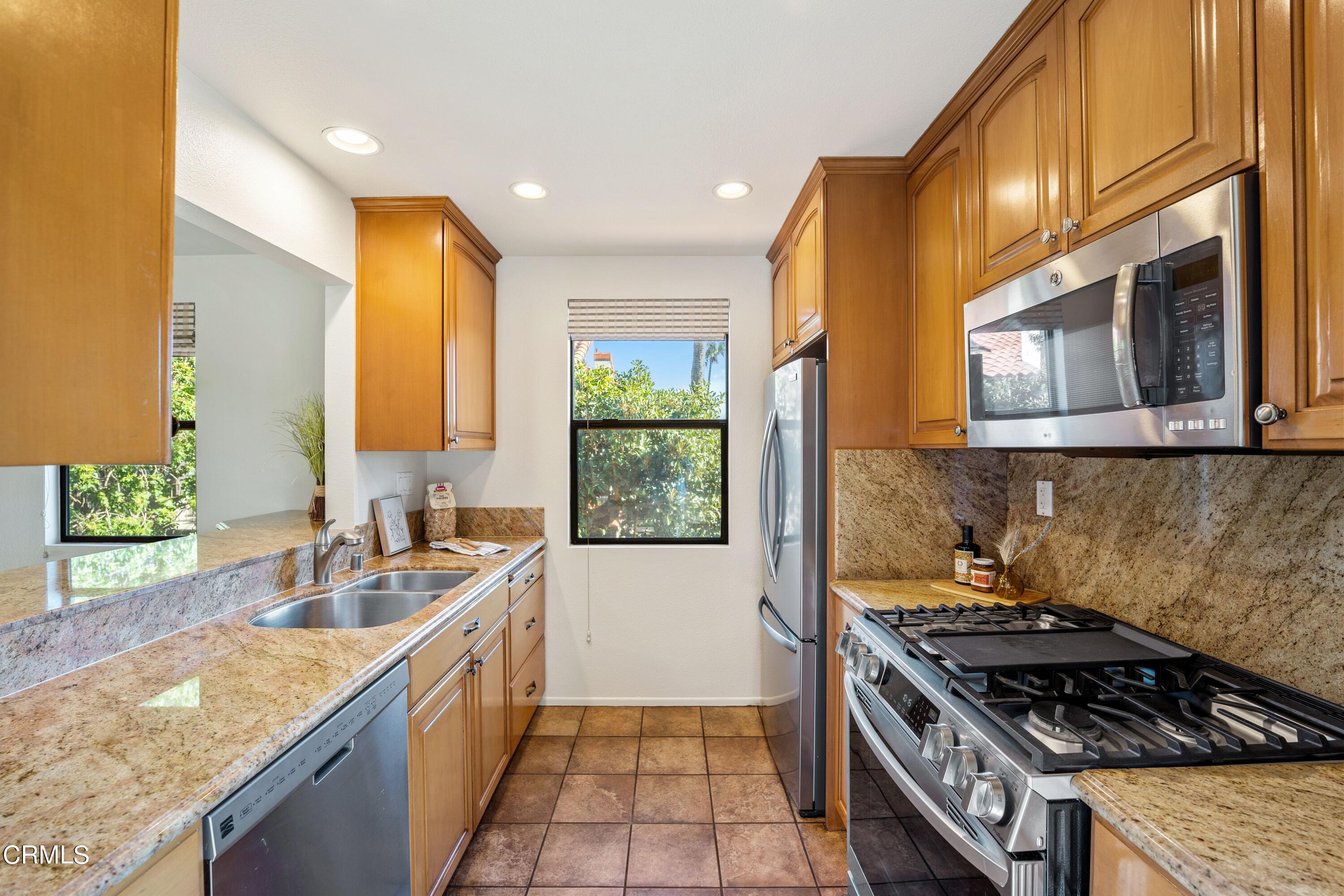 2041 Majorca Drive Oxnard, CA 93035 - Photo 11 of 31 a kitchen with a stove a sink and a refrigerator