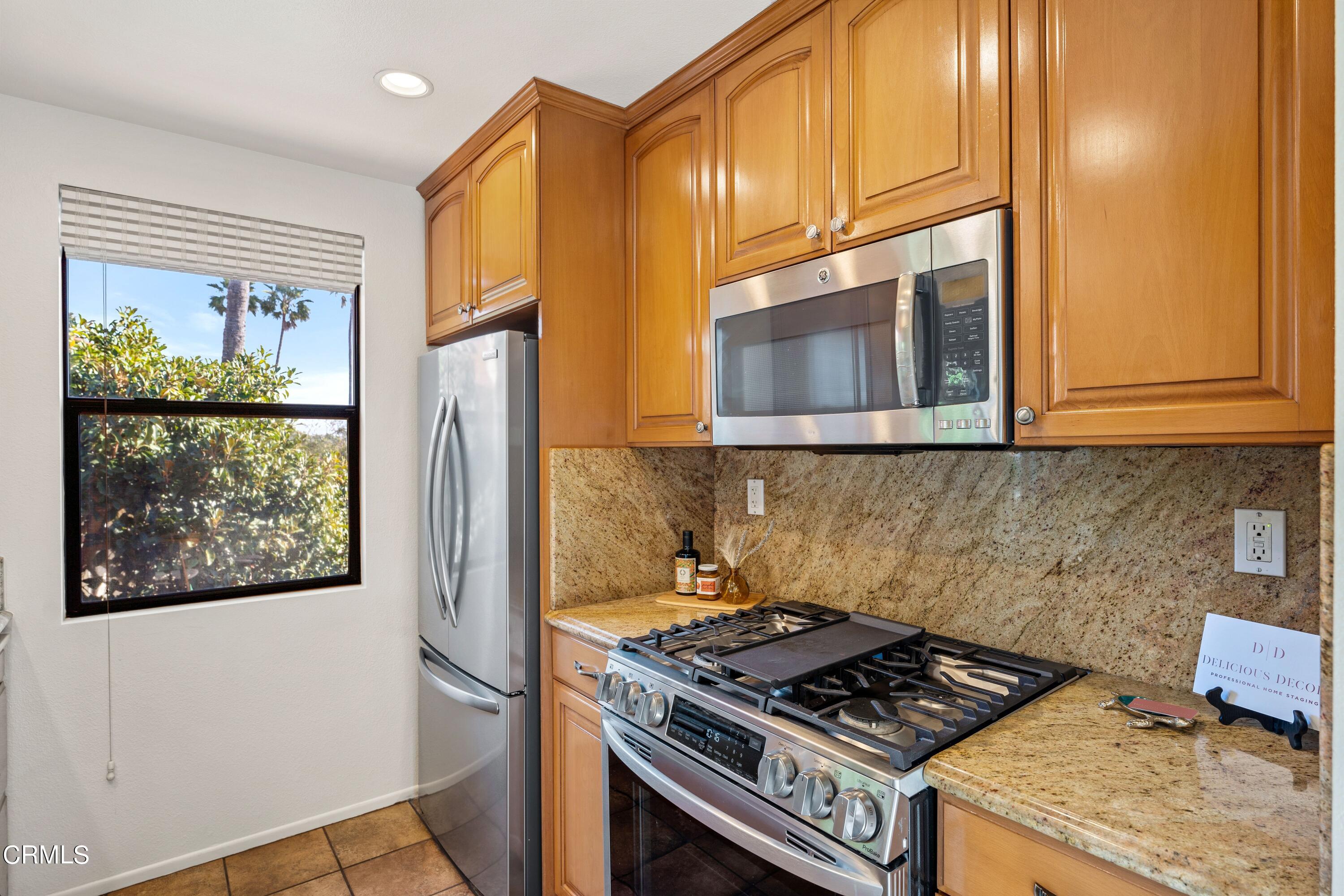 2041 Majorca Drive Oxnard, CA 93035 - Photo 12 of 31 a kitchen with stainless steel appliances granite countertop a stove a refrigerator and a microwave