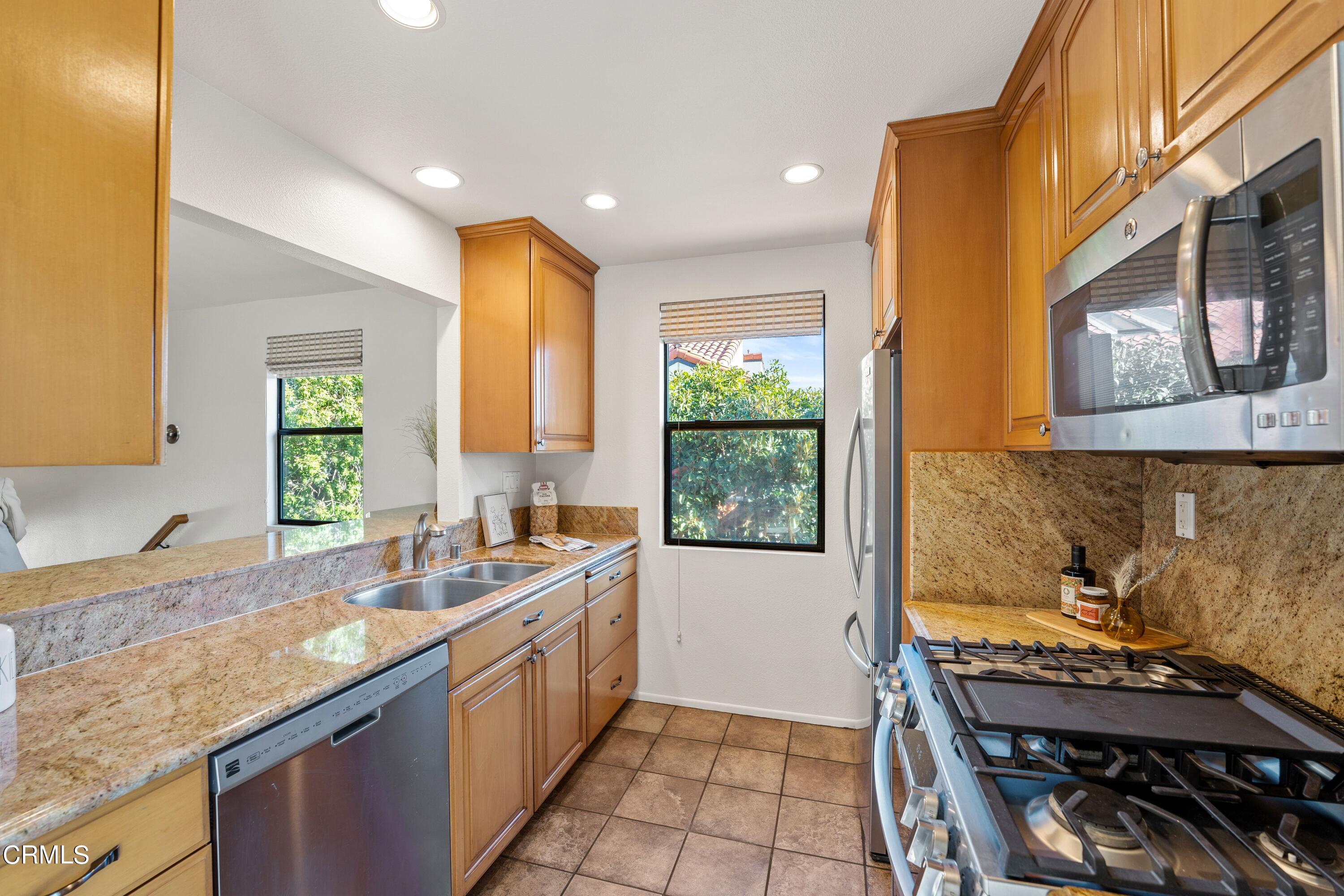 2041 Majorca Drive Oxnard, CA 93035 - Photo 14 of 31 a kitchen with a stove a sink and a refrigerator