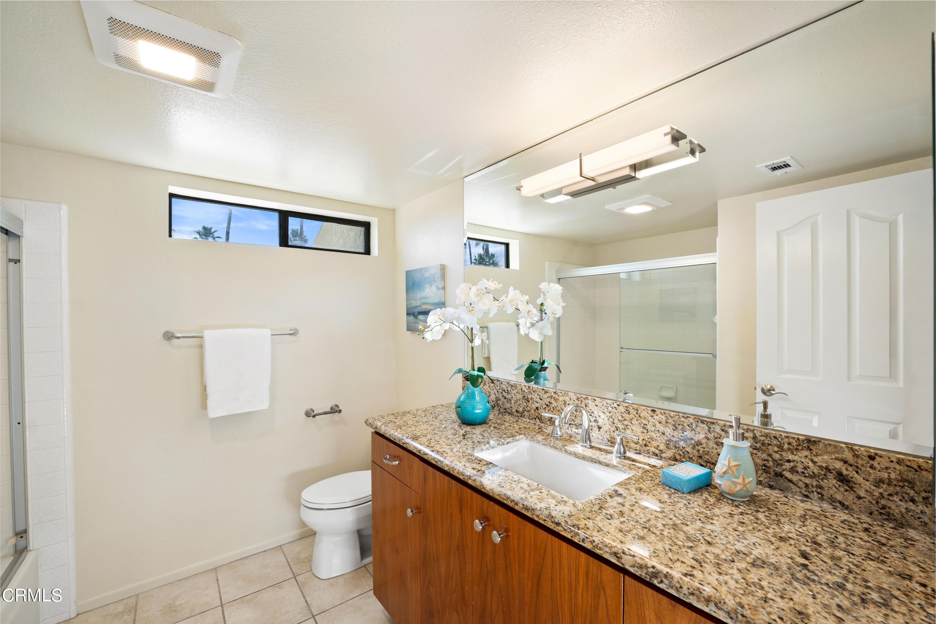 2041 Majorca Drive Oxnard, CA 93035 - Photo 15 of 31 a bathroom with a granite countertop sink a toilet a mirror and shower