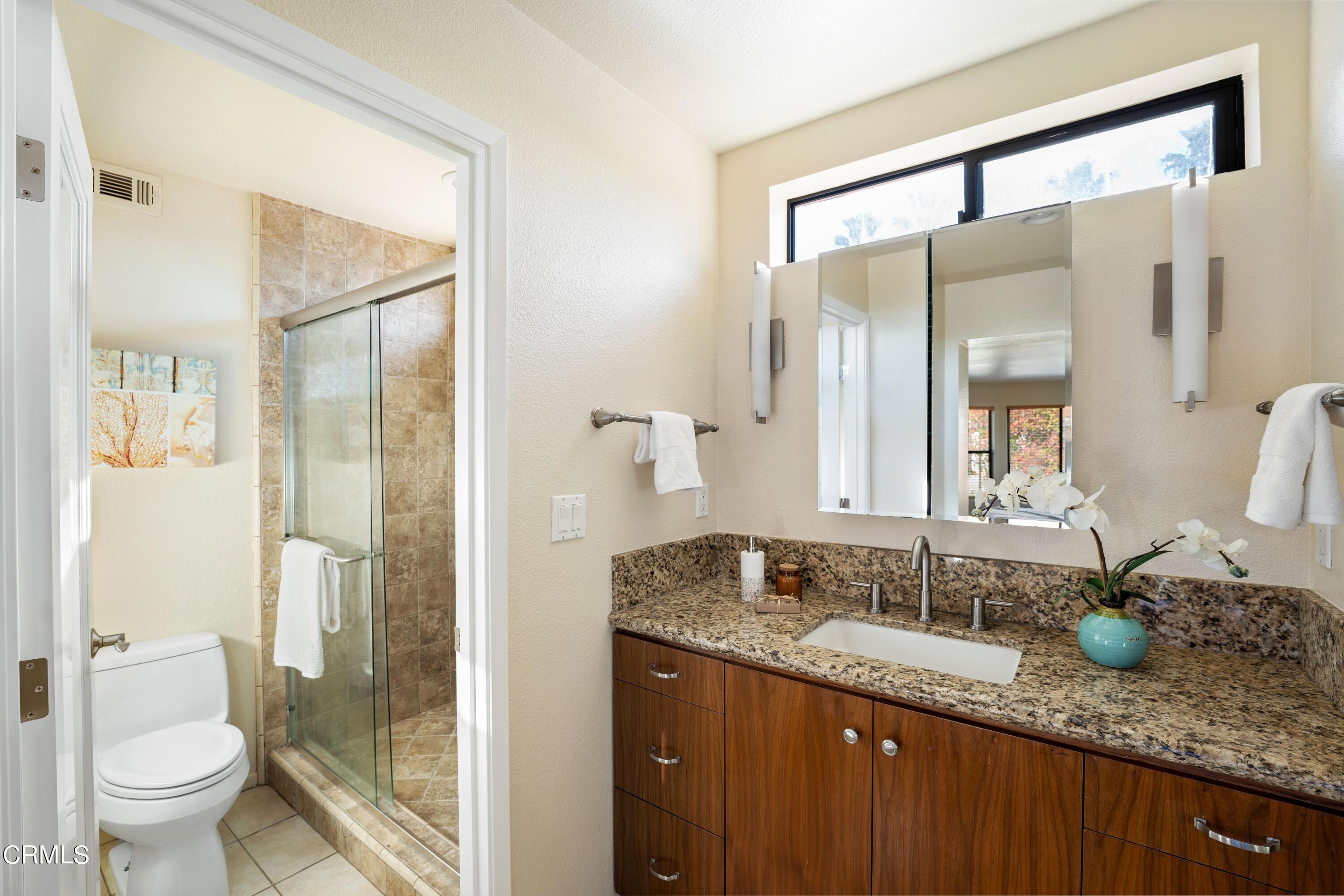 2041 Majorca Drive Oxnard, CA 93035 - Photo 18 of 31 a bathroom with a granite countertop sink and a mirror