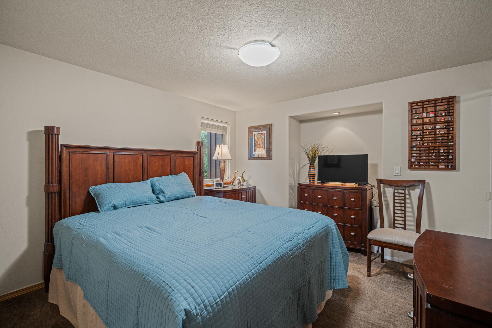 56019 Snow Goose Road Bend, OR 97707 - Photo 20 of 32 a bedroom with a bed and a couch