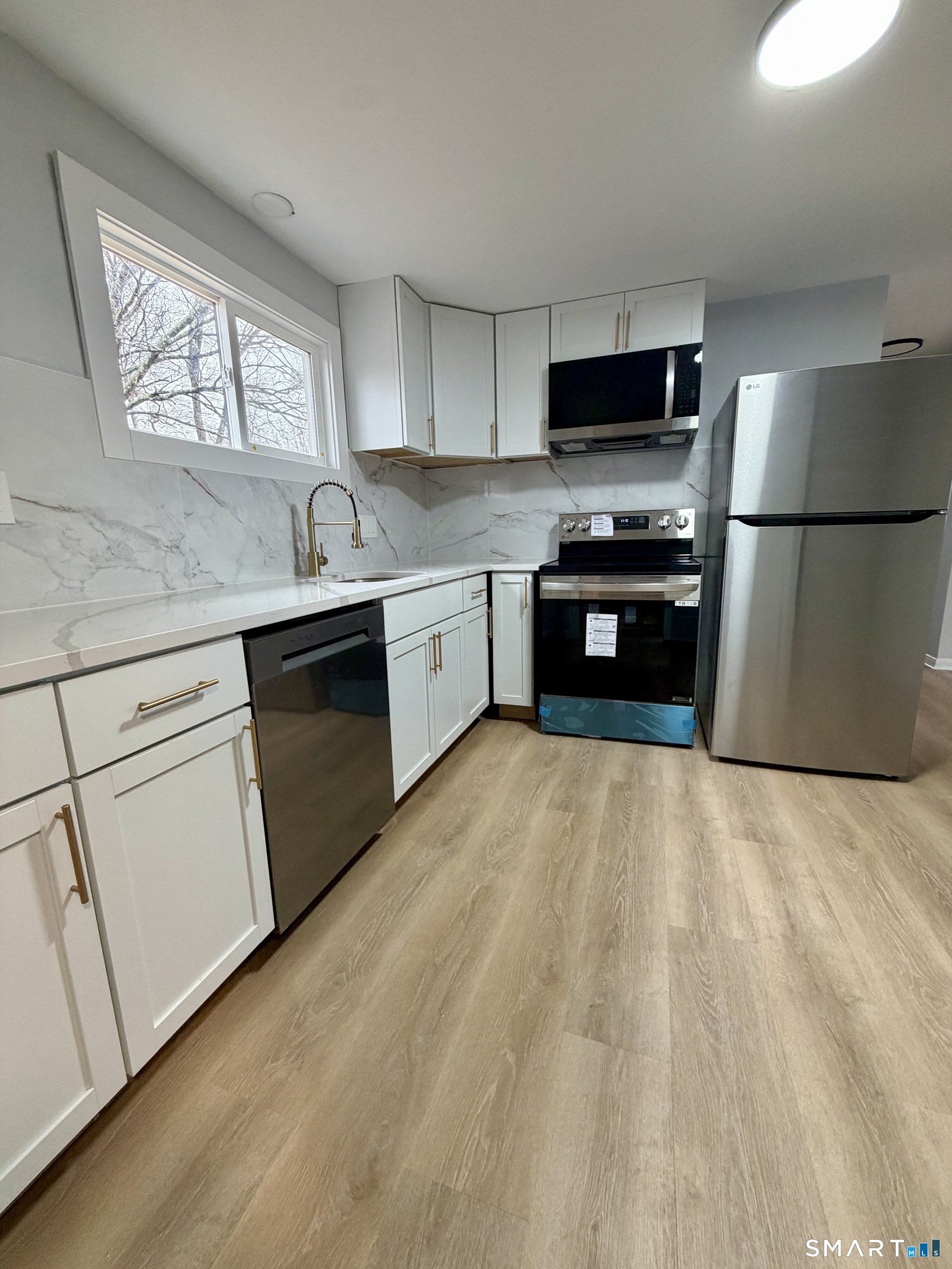 164 Sycamore Street, Unit 2R Bristol, CT 06010 - Photo 3 of 11 a kitchen with granite countertop a refrigerator and a sink