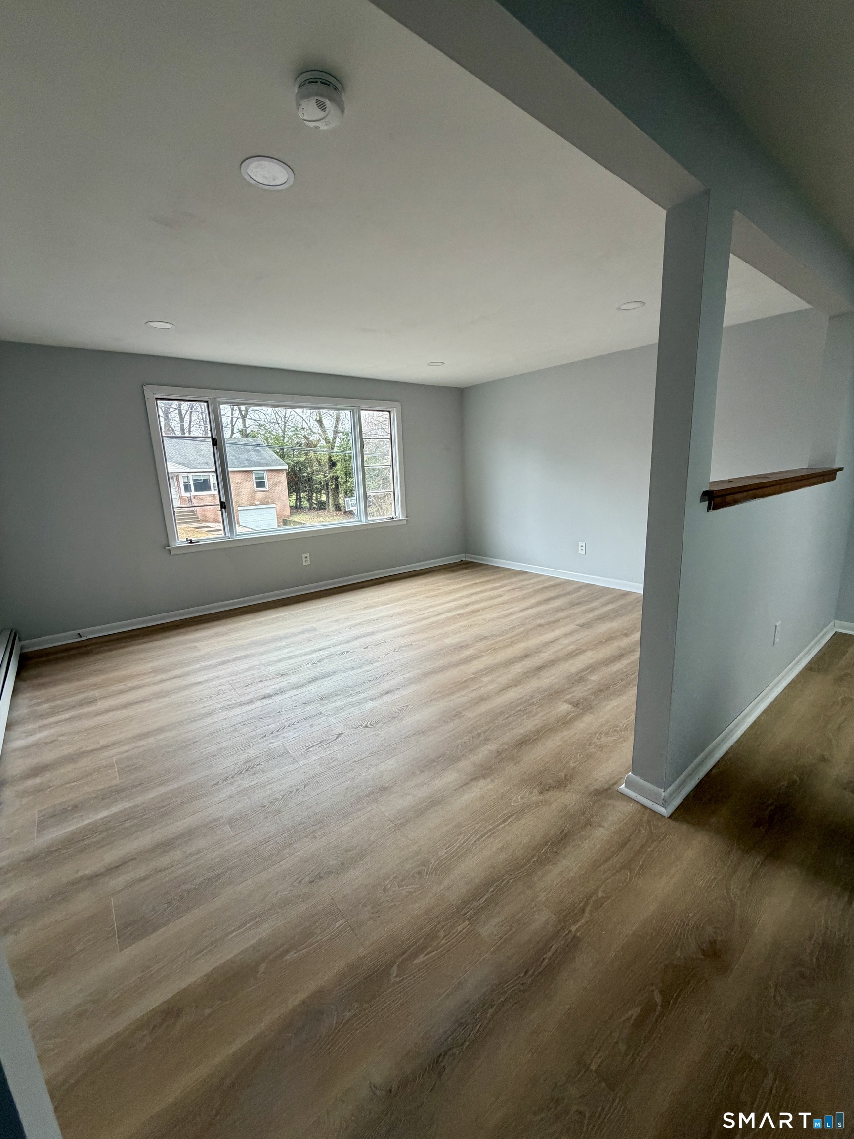 164 Sycamore Street, Unit 2R Bristol, CT 06010 - Photo 5 of 11 an empty room with wooden floor and window