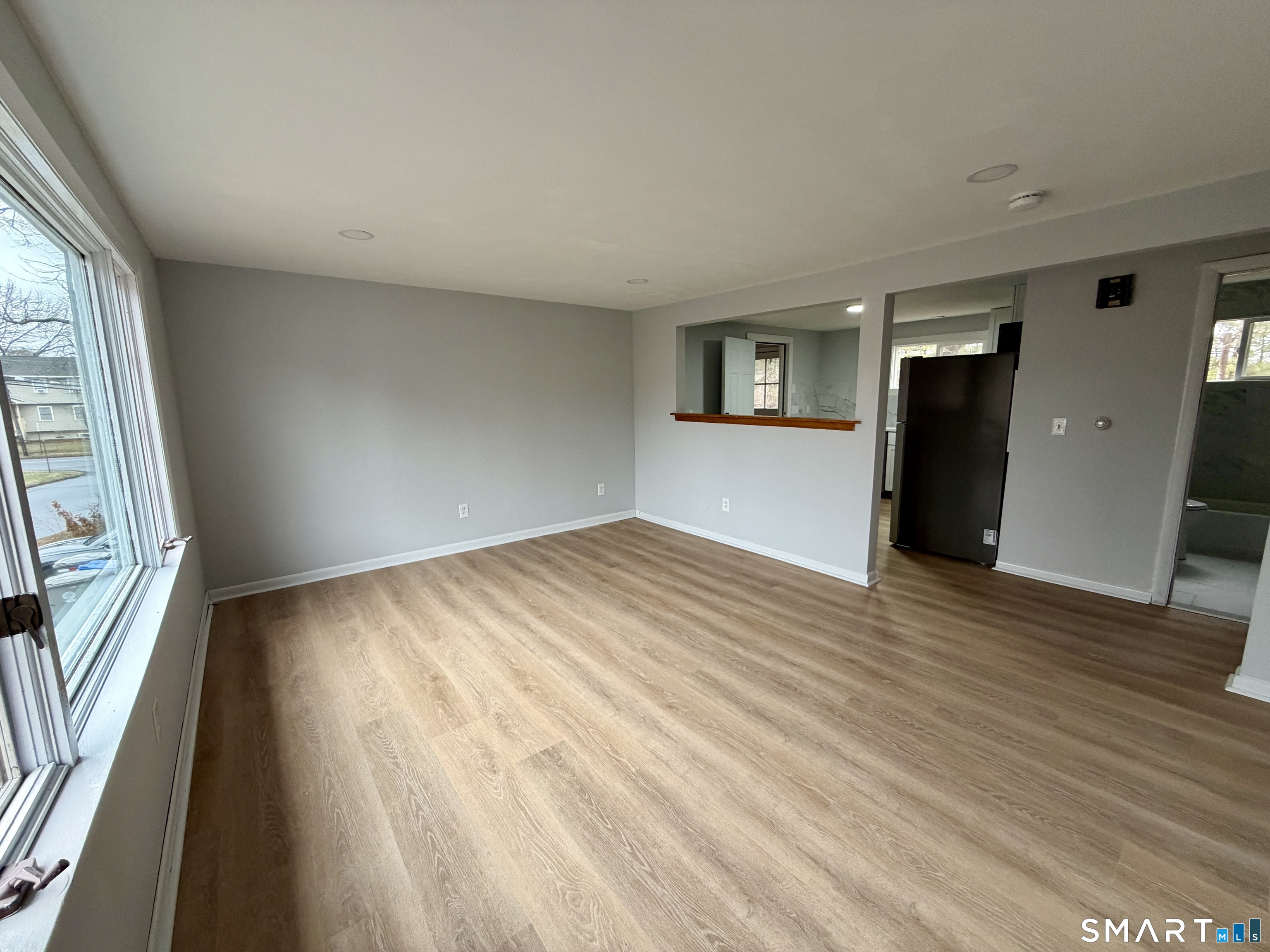 164 Sycamore Street, Unit 2R Bristol, CT 06010 - Photo 6 of 11 a view of empty room with wooden floor and fan