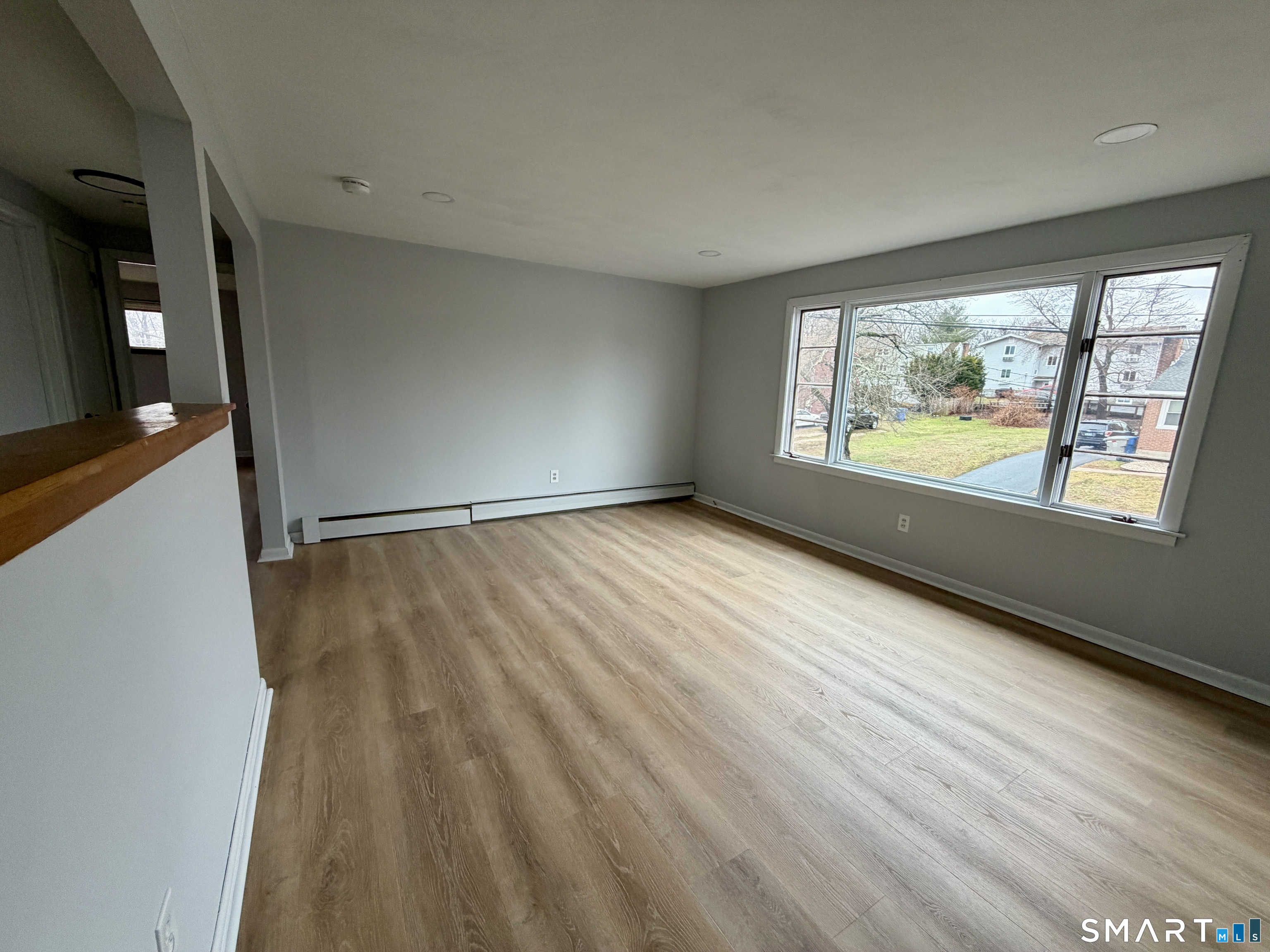 164 Sycamore Street, Unit 2R Bristol, CT 06010 - Photo 7 of 11 wooden floor in an empty room with a window