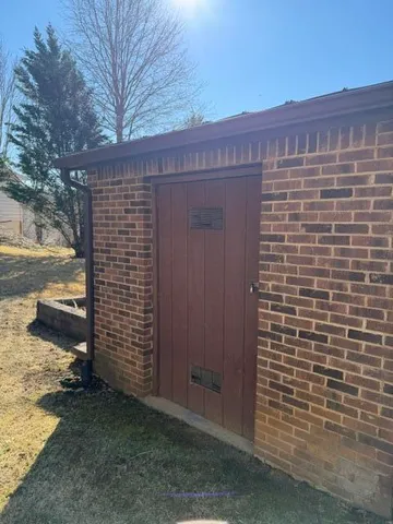 a view of a pathway of a house with a yard