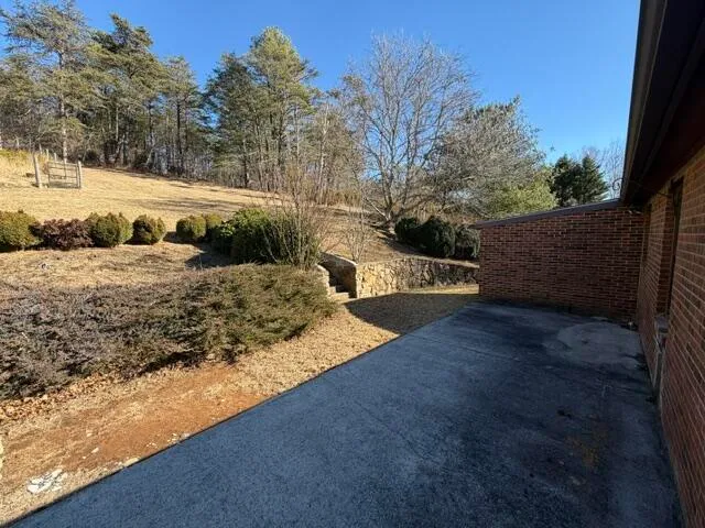 a view of a yard with wooden fence