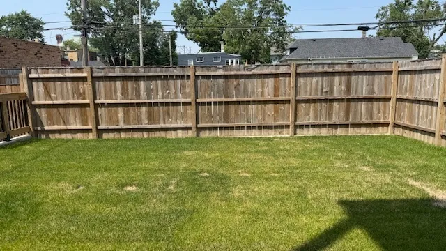 a backyard with a garden and deck