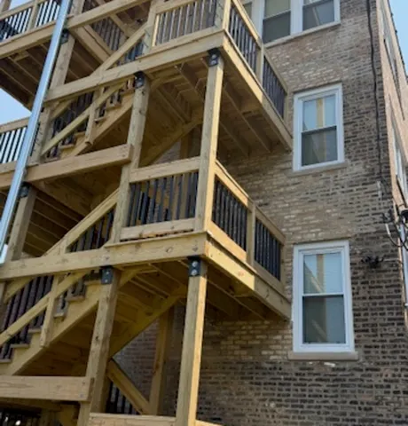 a view of a house with wooden stairs