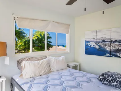 a bedroom with a large bed and a window