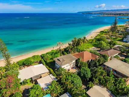 an aerial view of a house with a yard