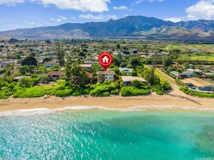 an aerial view of multiple house with a mountain