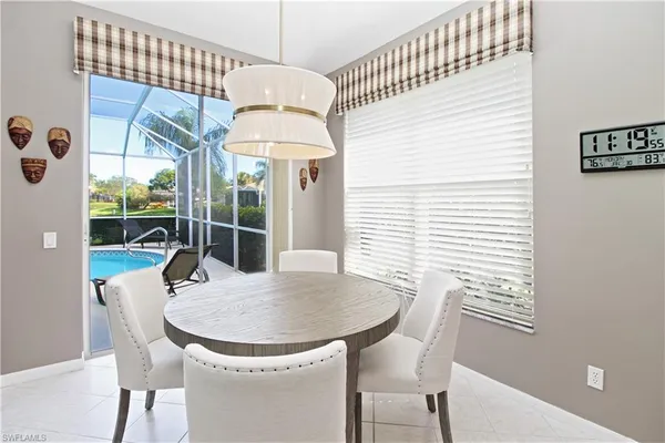 a dining room with furniture and window
