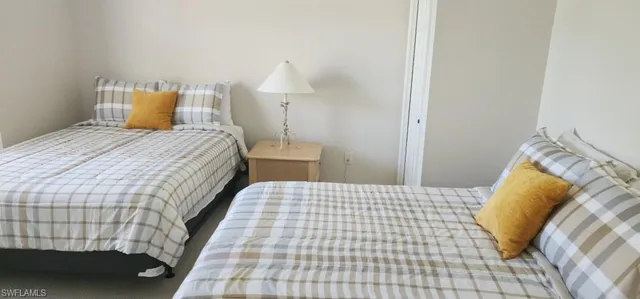 a bedroom with a bed and a lamp