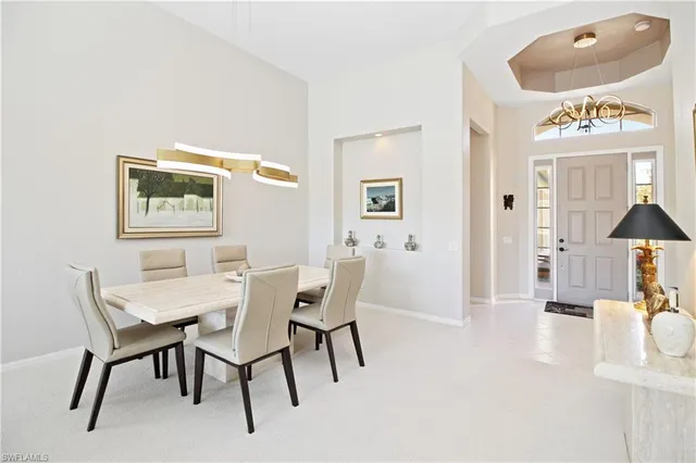 a view of a dining room with furniture and a chandelier