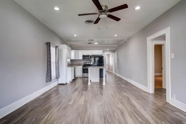 a view of kitchen with stainless steel appliances refrigerator microwave and stove