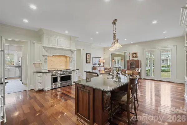 a kitchen with granite countertop a sink stainless steel appliances and cabinets