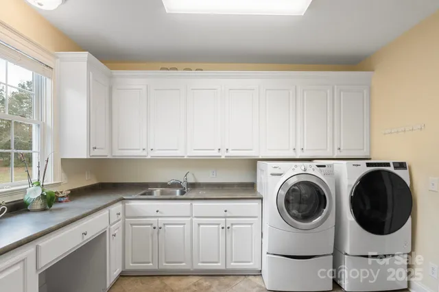 a kitchen with granite countertop a toilet a sink and a window