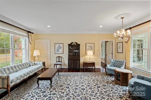 a living room with furniture and a chandelier