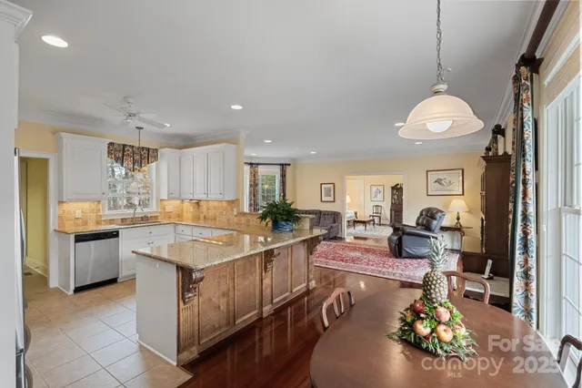 a kitchen with a stove and living room
