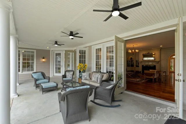 a living room with furniture and a glass door shower