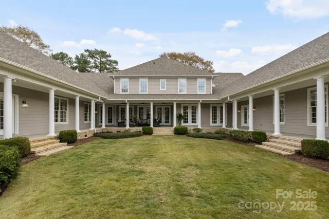 a front view of a house with swimming pool and porch