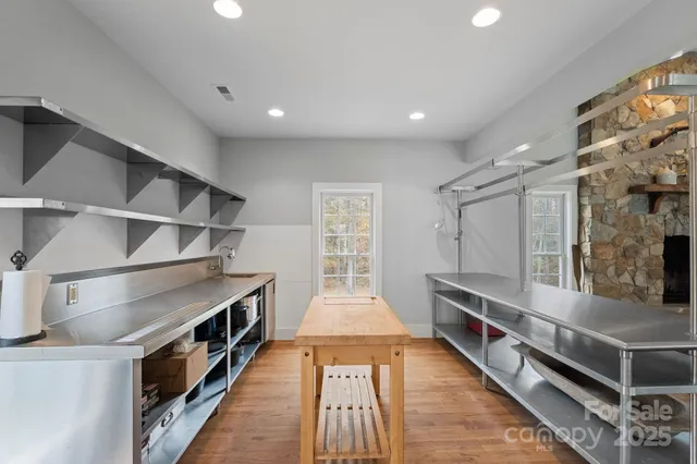 a kitchen with stainless steel appliances a stove and more cabinets