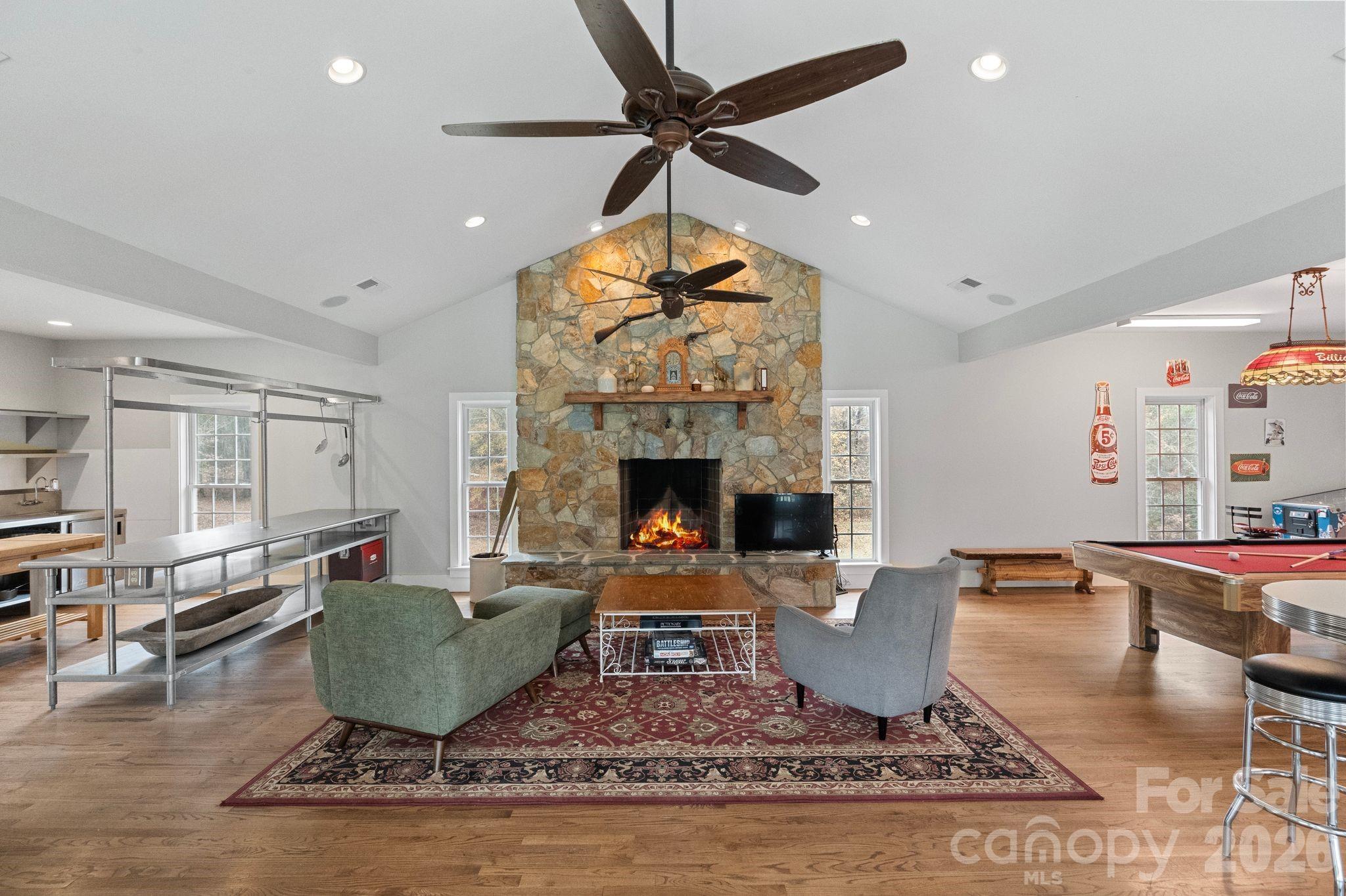 393 Youngs Bend Road Kershaw, SC 29067 - Photo 40 of 48 a living room with furniture a fireplace and a chandelier