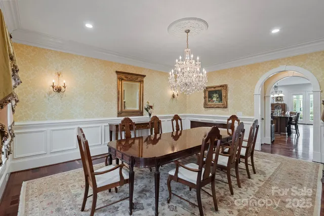 a view of a dining room with furniture and chandelier