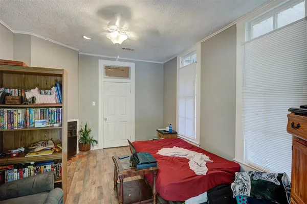a bedroom with a bed and a book shelf