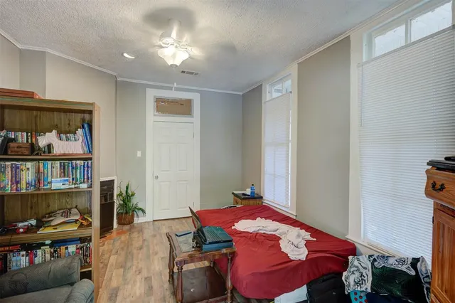 a bedroom with a bed and a book shelf