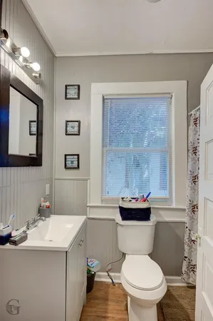 a bathroom with a sink mirror toilet and shower