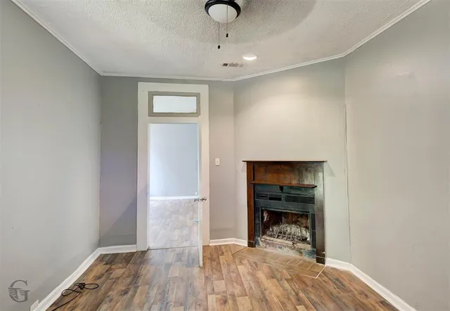 a view of a livingroom with wooden floor and a ceiling fan