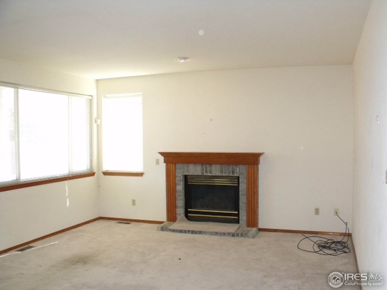 633 Rider Ridge Drive Longmont, CO 80504 - Photo 3 of 3 an empty room with a fireplace