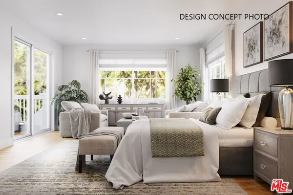 a bedroom with furniture and a large window