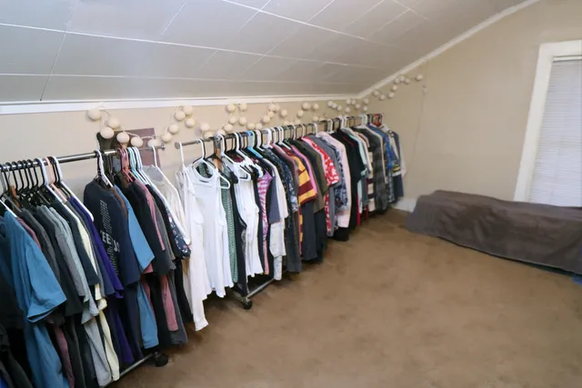 a view of walk in closet with clothes