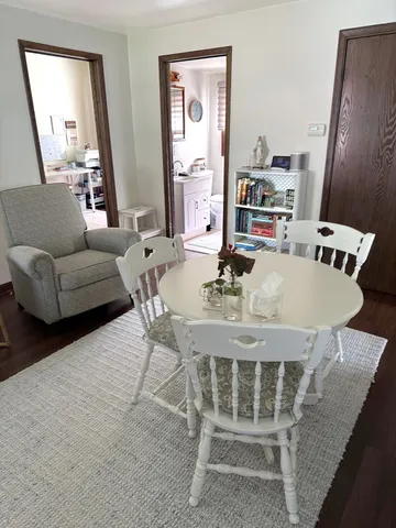 a dining room with furniture and wooden floor