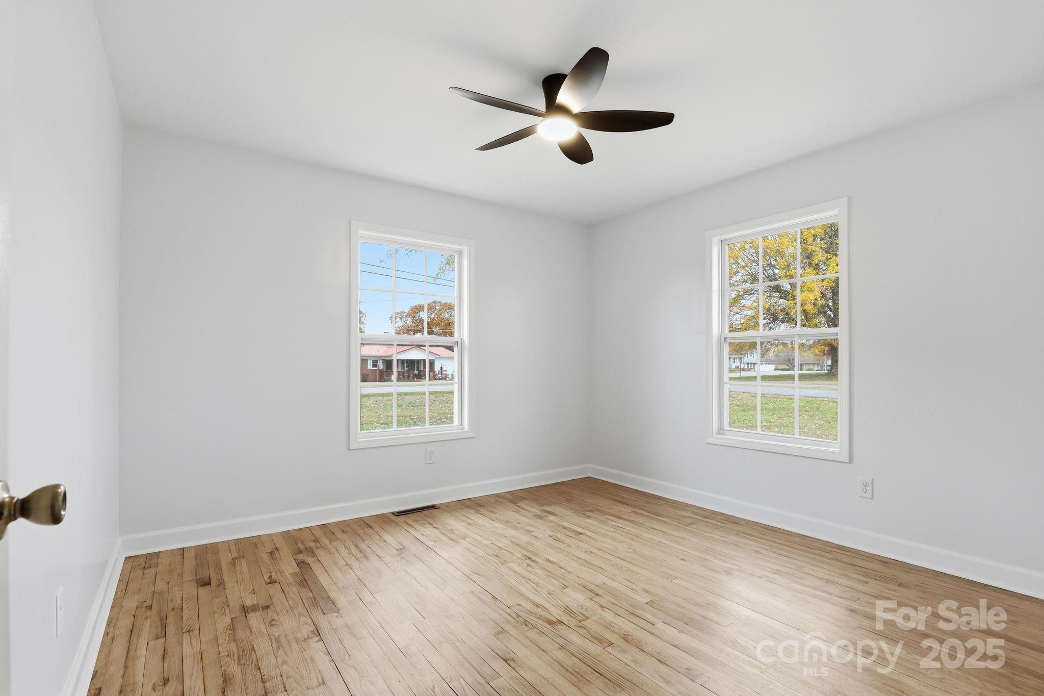 1618 Union Grove Road Lenoir, NC 28645 - Photo 13 of 24 a view of a big room with wooden floor and windows