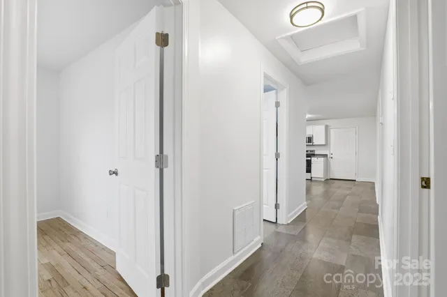 a view of a hallway with two rooms