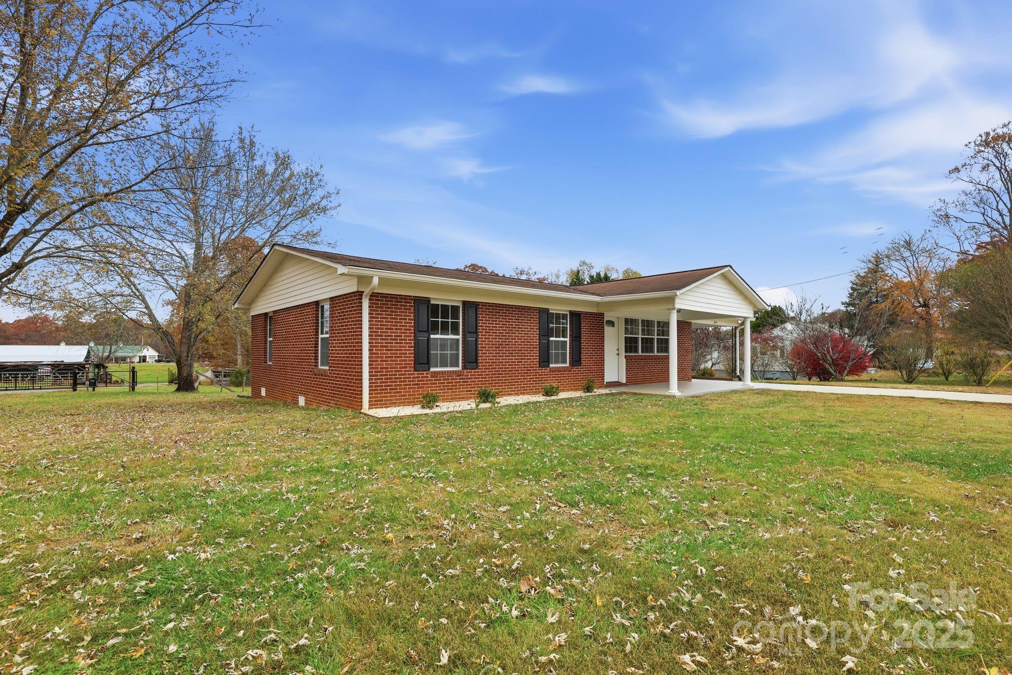 1618 Union Grove Road Lenoir, NC 28645 - Photo 2 of 24 a view of a yard in front of a house with large trees