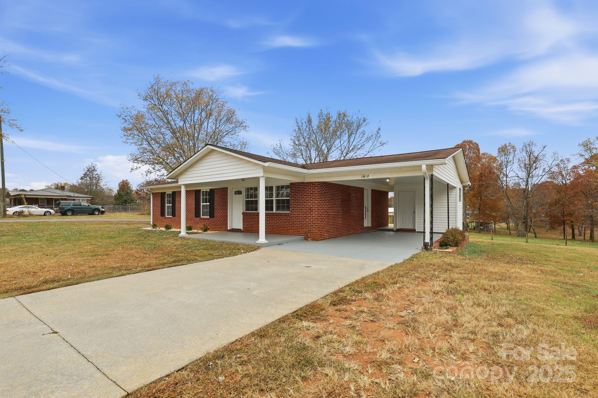 1618 Union Grove Road Lenoir, NC 28645 - Photo 4 of 24 a front view of a house with a yard and garage