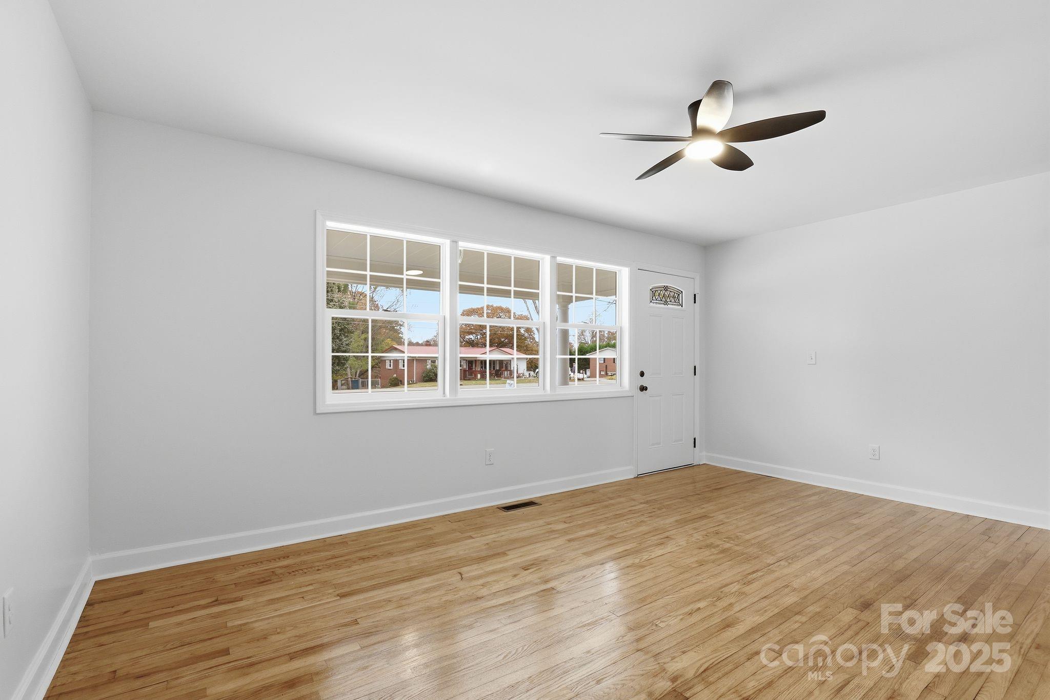 1618 Union Grove Road Lenoir, NC 28645 - Photo 7 of 24 a view of empty room with wooden floor and fan