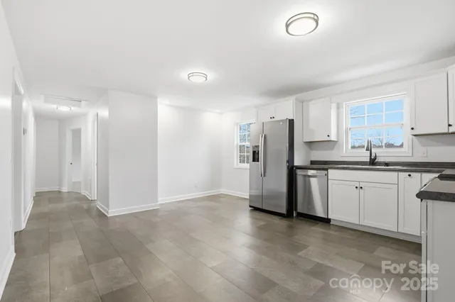 a kitchen with refrigerator and cabinets