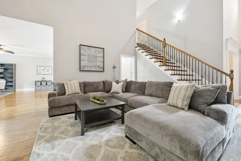a kitchen with stainless steel appliances granite countertop a sink refrigerator and cabinets