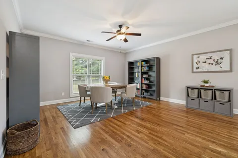 a view of a dining room with furniture and chandelier