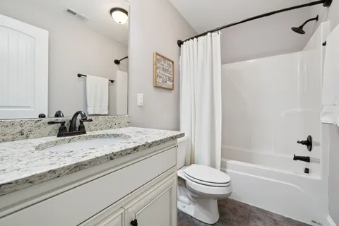 a view of swimming pool with seating area and trees in the background