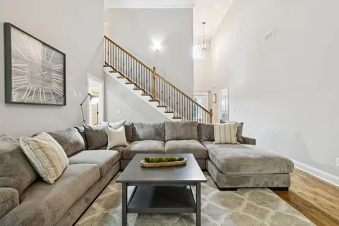 a living room with furniture and stairs