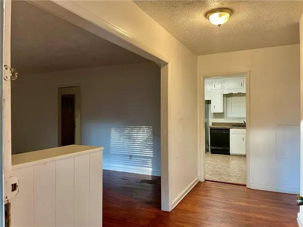 a view of hallway with wooden floor
