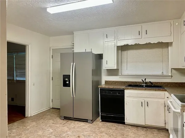 a kitchen with a sink stove and refrigerator